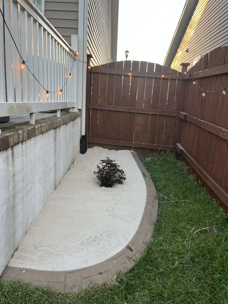 Planting bed cut into a concrete patio corner
