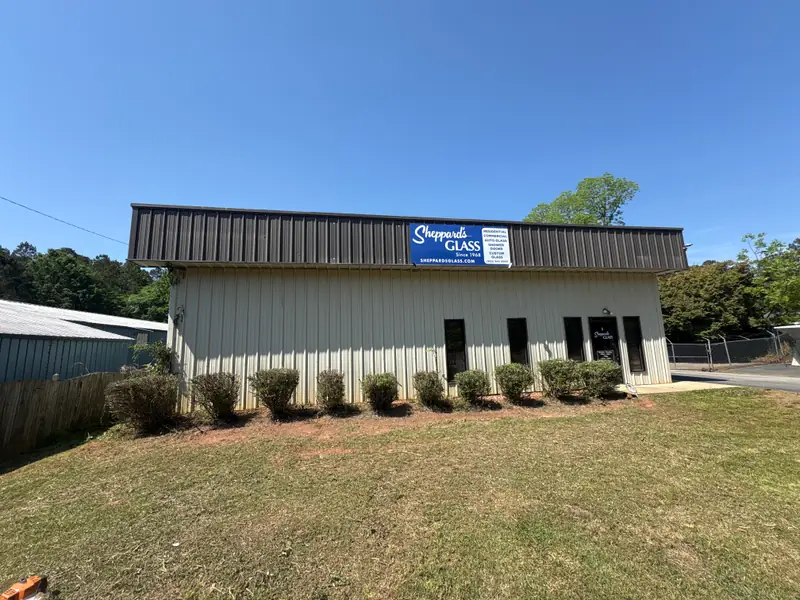 Trimmed shrub line along a commercial building