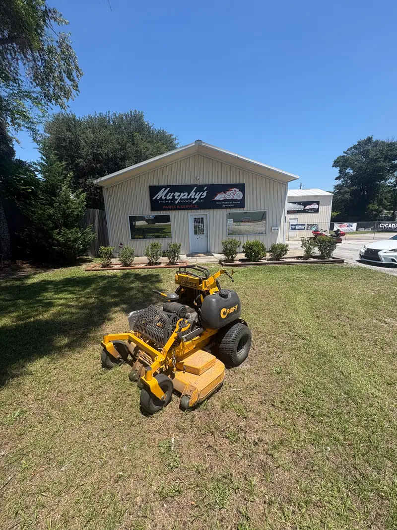 Mowed frontage and trimmed shrubs at a commercial storefront