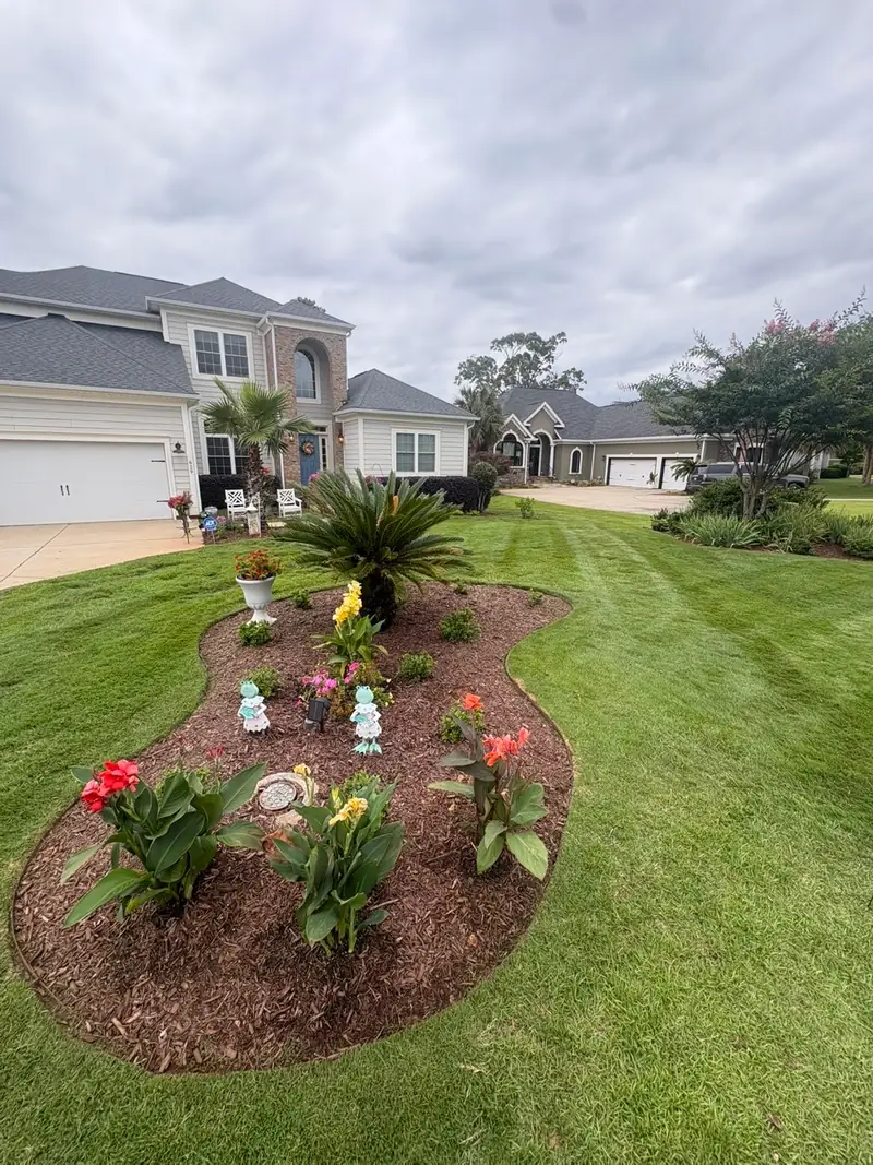 Curved flower bed island planted with seasonal color