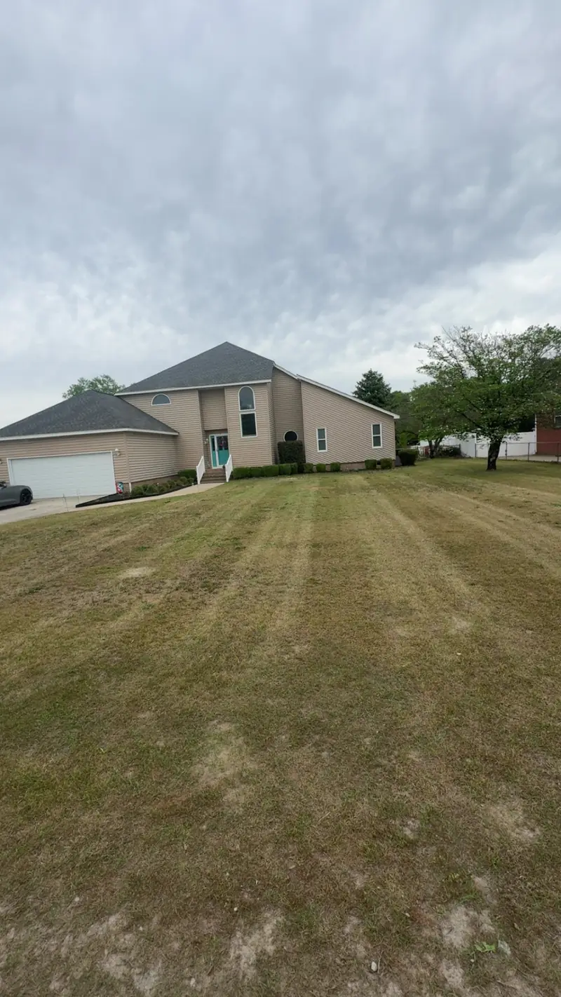 Freshly mowed front lawn at a stucco home