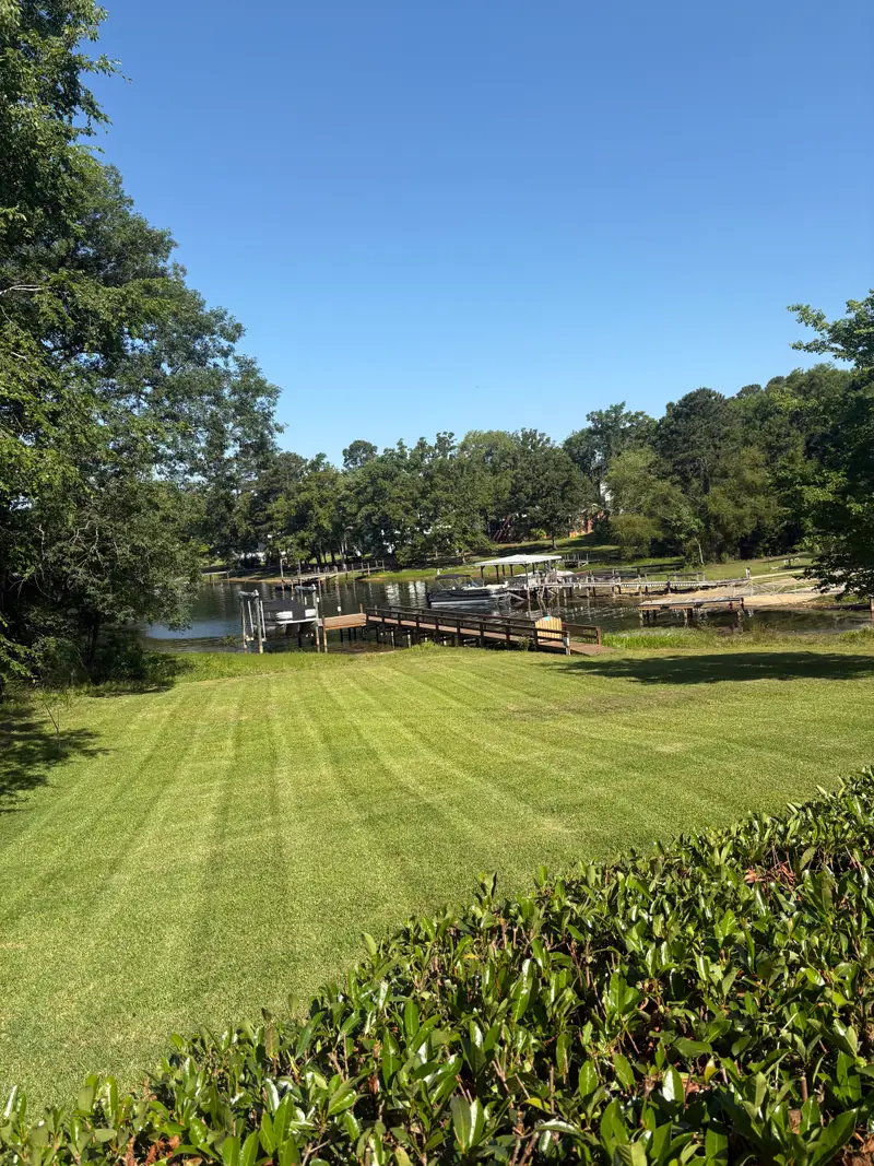 Striped lawn running down to a private dock on Lake Murray
