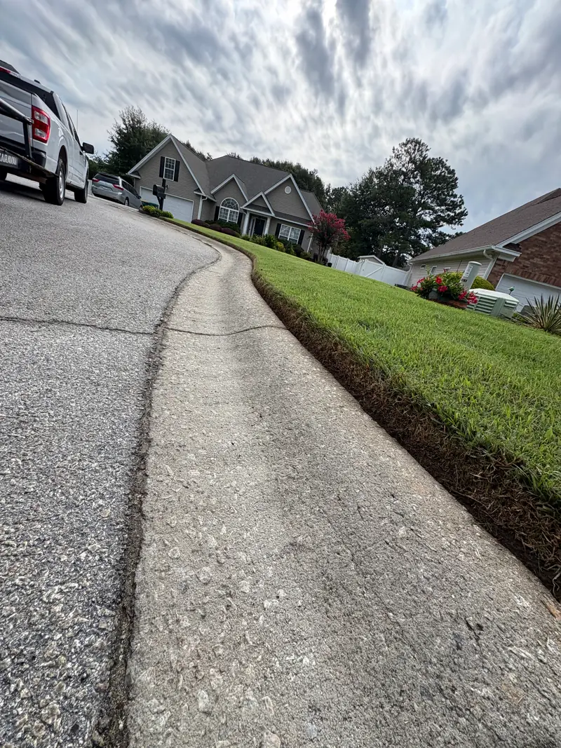 Crisp lawn edge along a driveway and curb