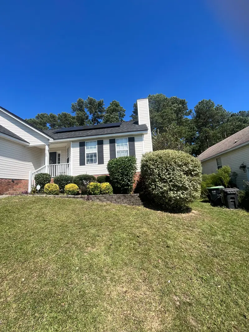 Trimmed shrubs and mowed lawn at a ranch home
